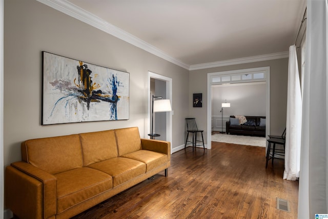 living room featuring dark wood-style floors, baseboards, visible vents, and ornamental molding