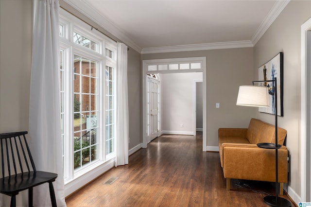 interior space featuring dark wood-style floors, ornamental molding, visible vents, and baseboards