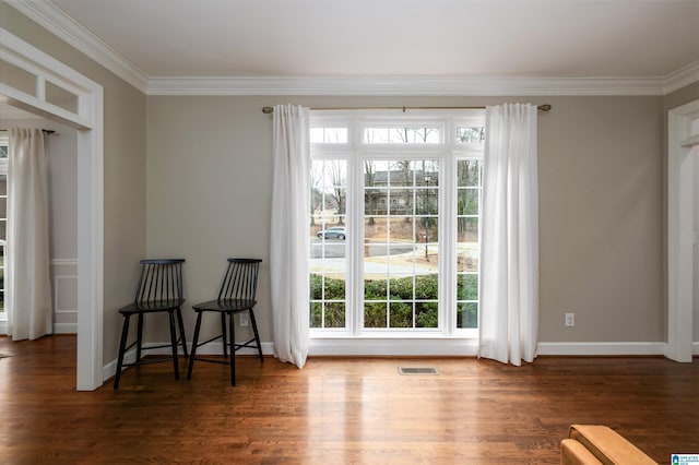 doorway to outside featuring dark wood-style flooring, visible vents, and crown molding