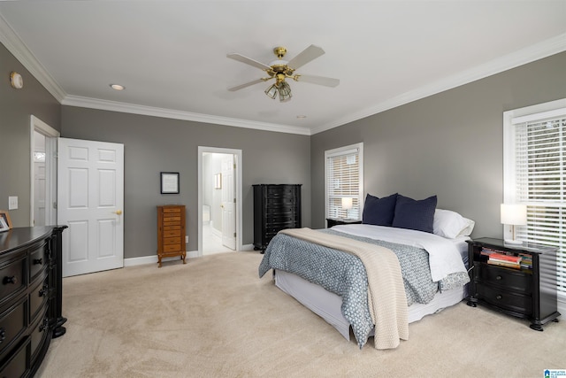 bedroom with connected bathroom, light carpet, a ceiling fan, baseboards, and crown molding