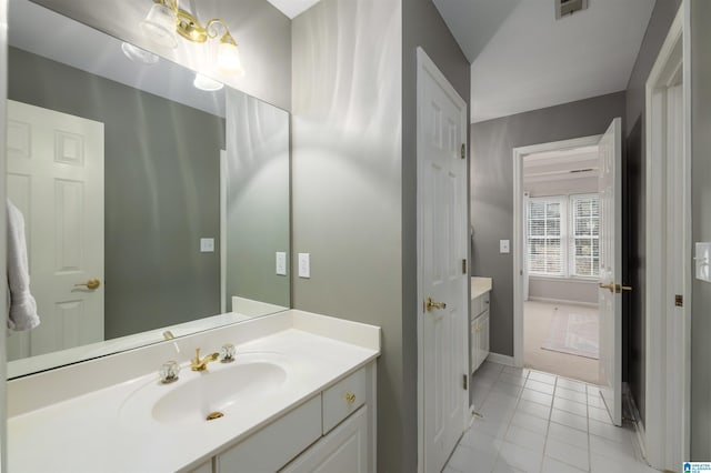 bathroom with visible vents, tile patterned flooring, vanity, and baseboards