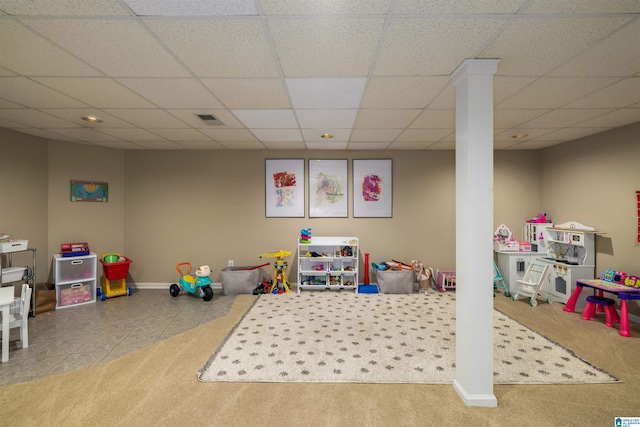 recreation room featuring a drop ceiling, tile patterned flooring, carpet floors, visible vents, and baseboards