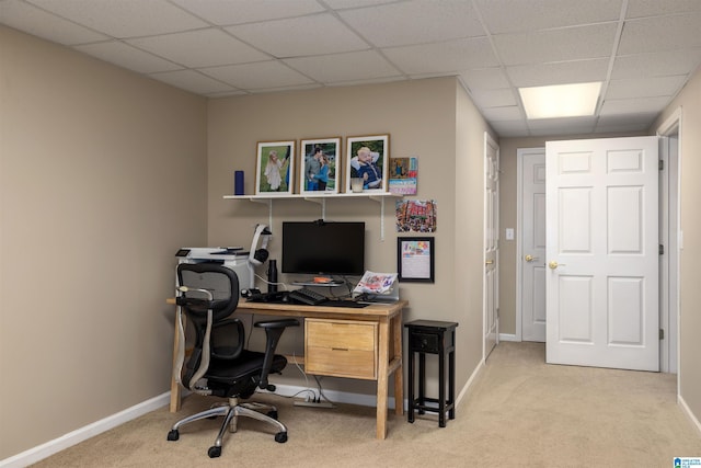 carpeted home office featuring a paneled ceiling and baseboards