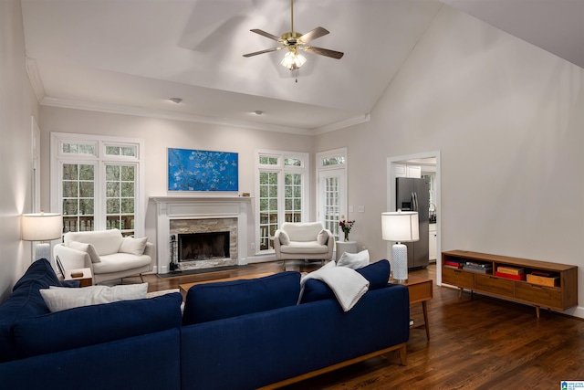 living area with dark wood-style floors, a fireplace, crown molding, ceiling fan, and high vaulted ceiling