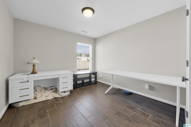 office area featuring baseboards, visible vents, and wood finish floors