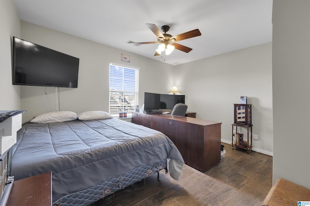 bedroom featuring dark wood-style floors, baseboards, and a ceiling fan