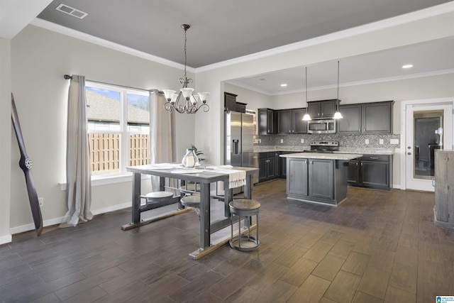 kitchen with visible vents, decorative backsplash, appliances with stainless steel finishes, decorative light fixtures, and light countertops