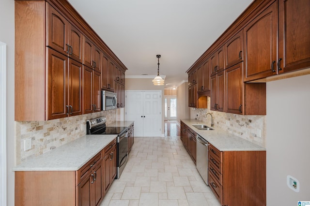 kitchen with light countertops, appliances with stainless steel finishes, a sink, and decorative backsplash