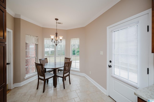 dining space with an inviting chandelier, baseboards, visible vents, and ornamental molding