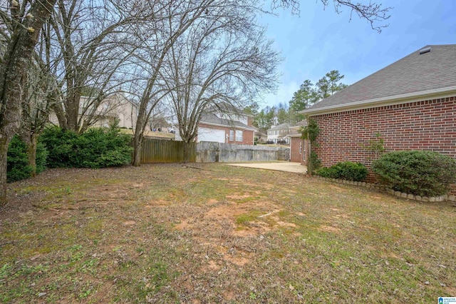 view of yard featuring fence and a patio