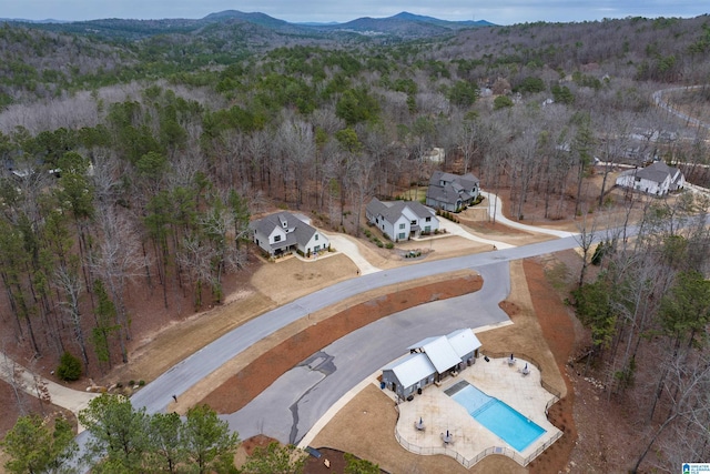 aerial view featuring a forest view and a mountain view