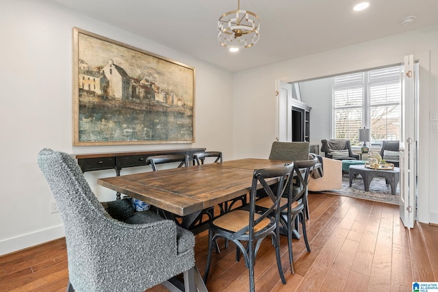 dining room with recessed lighting, a notable chandelier, baseboards, and wood finished floors