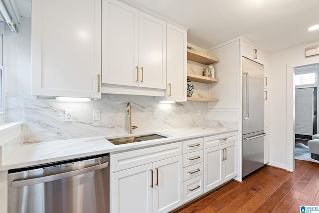 kitchen with open shelves, white cabinetry, stainless steel appliances, and a sink