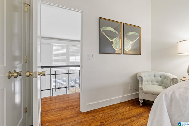 sitting room with wood finished floors and baseboards