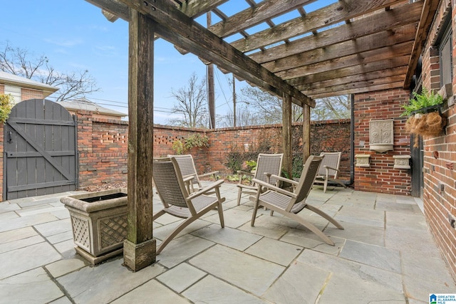 view of patio / terrace with a fenced backyard, a gate, and a pergola