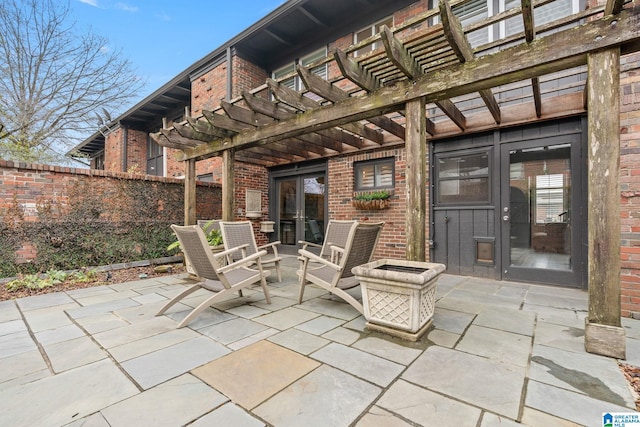 view of patio / terrace with an outdoor fire pit, fence, and a pergola