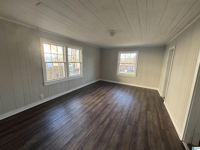 unfurnished room with crown molding, wooden ceiling, dark wood finished floors, and baseboards