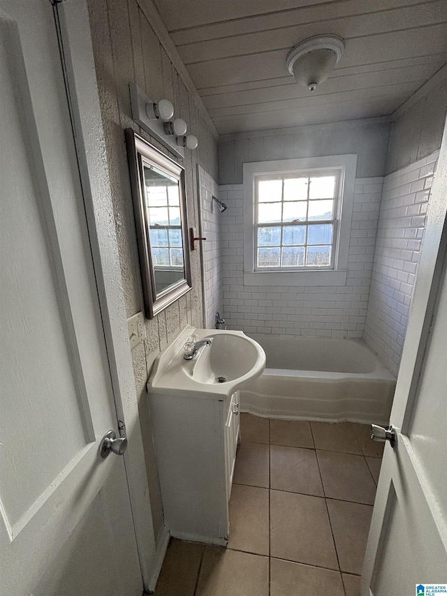 bathroom with bathing tub / shower combination, vanity, and tile patterned floors