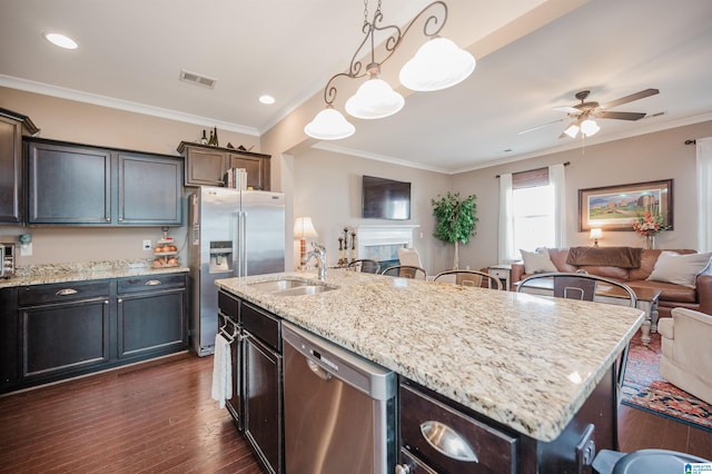 kitchen with visible vents, open floor plan, dark wood-type flooring, stainless steel appliances, and a sink