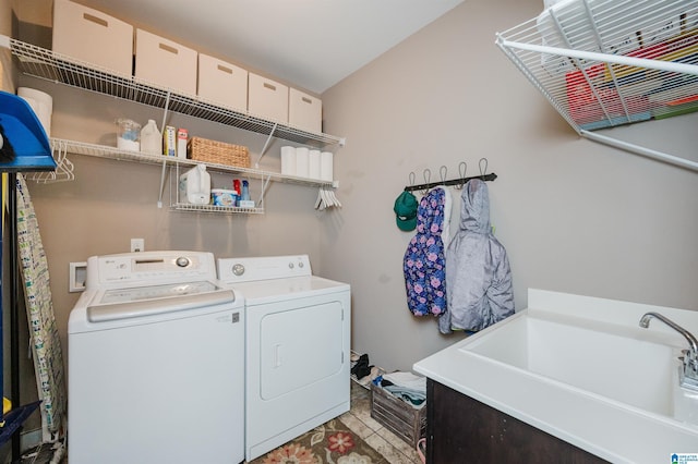 laundry area featuring laundry area, a sink, and washing machine and clothes dryer