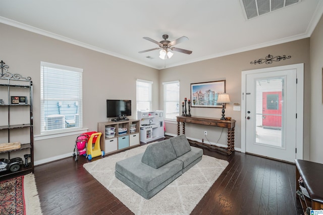 living area featuring baseboards, visible vents, dark wood finished floors, and crown molding