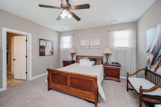 carpeted bedroom with visible vents, ceiling fan, and baseboards