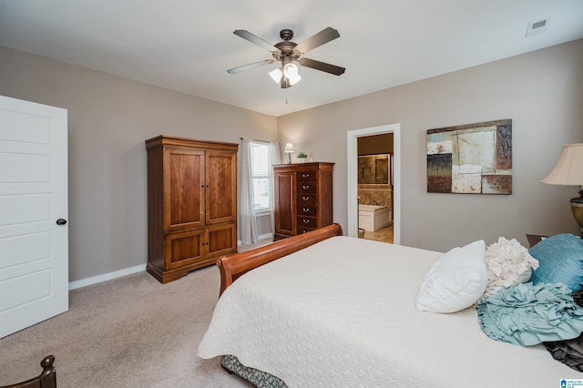 bedroom with visible vents, light carpet, ceiling fan, ensuite bath, and baseboards