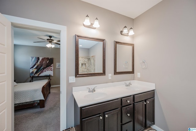 full bath with baseboards, a sink, ensuite bath, and double vanity