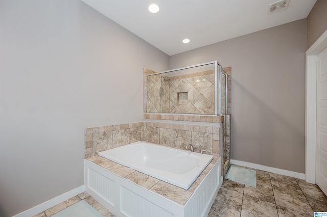 full bath featuring a garden tub, a shower stall, visible vents, and baseboards