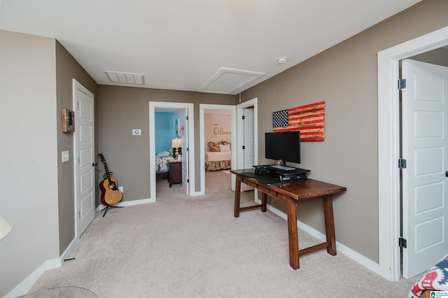 office space featuring attic access, visible vents, baseboards, and light colored carpet