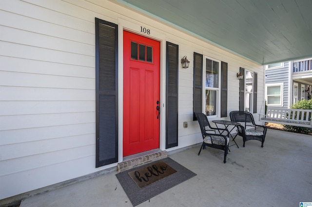 view of exterior entry with a porch