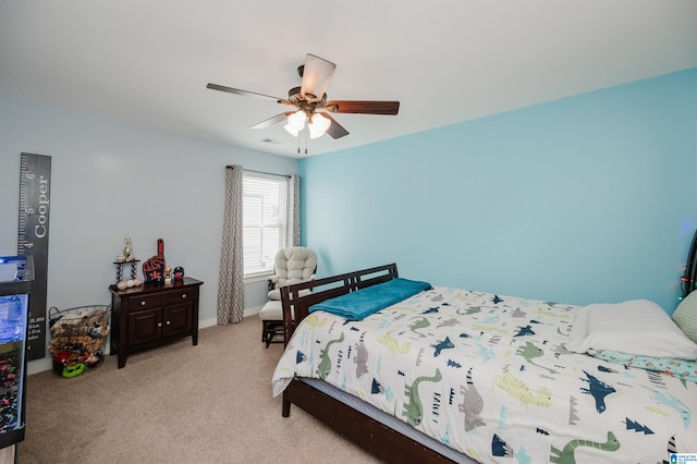 bedroom with light colored carpet, ceiling fan, and visible vents