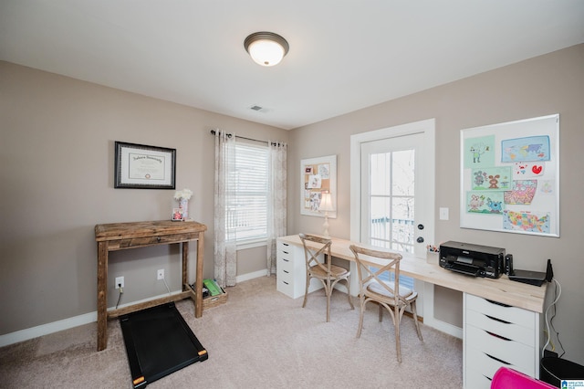 office space with baseboards, visible vents, and light colored carpet