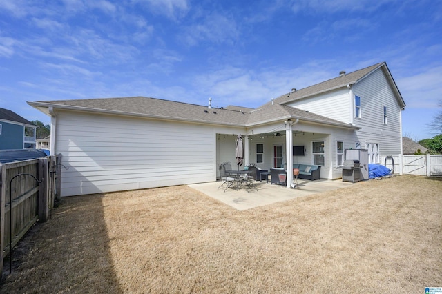 rear view of house with a gate, a patio area, a fenced backyard, and an outdoor hangout area