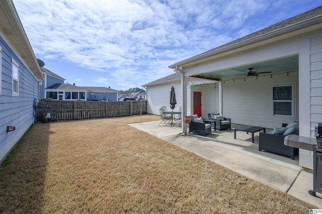 view of yard with a ceiling fan, fence, a patio, and an outdoor hangout area