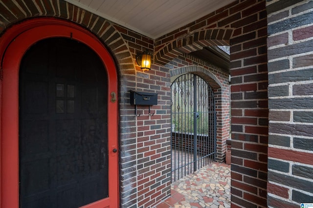 property entrance featuring brick siding