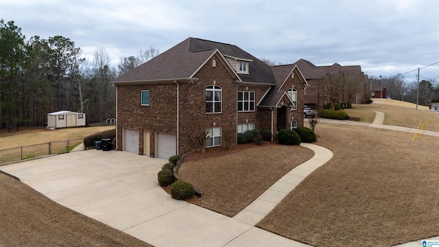 view of front of house with a garage, brick siding, fence, concrete driveway, and a front yard