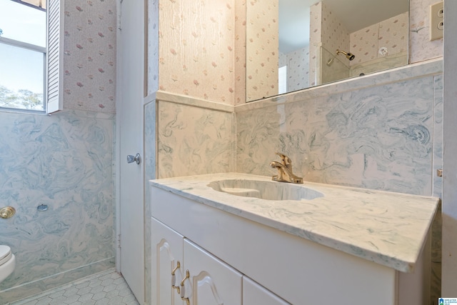 full bathroom featuring toilet, vanity, tile patterned floors, walk in shower, and wallpapered walls