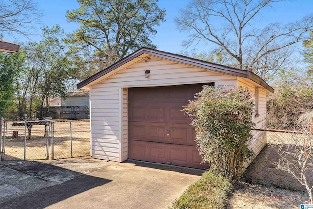 detached garage with driveway and fence