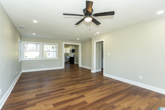 unfurnished living room featuring dark wood-style floors, baseboards, and recessed lighting