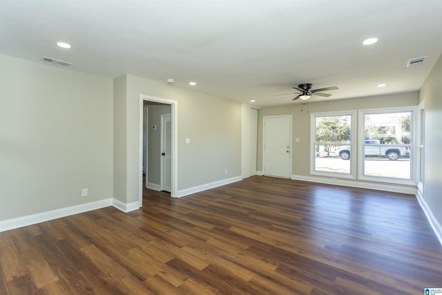 unfurnished room featuring dark wood-type flooring, recessed lighting, and visible vents