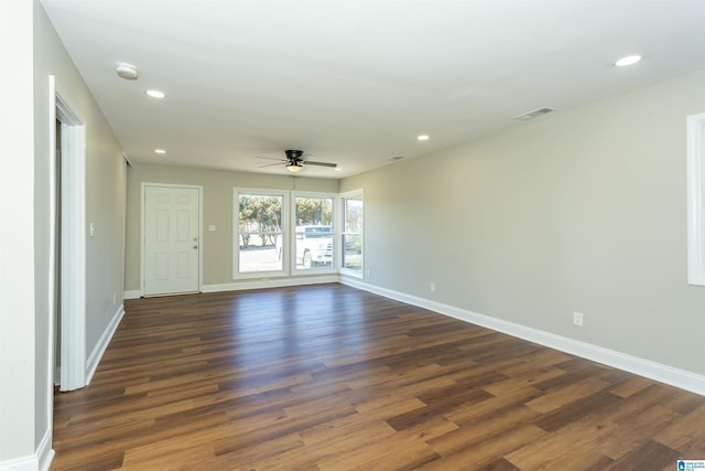 spare room with dark wood-style floors, recessed lighting, visible vents, and baseboards