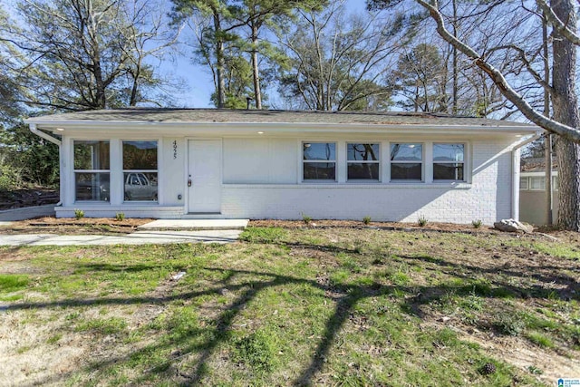 view of front facade featuring a front yard and brick siding