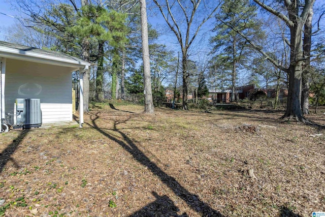 view of yard featuring fence and central air condition unit