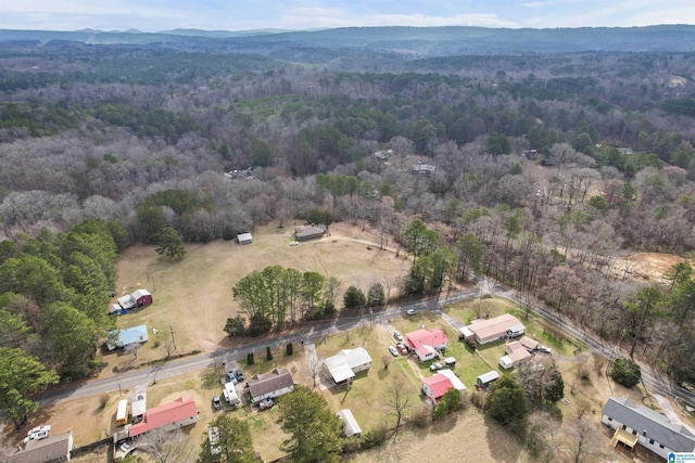 birds eye view of property with a view of trees