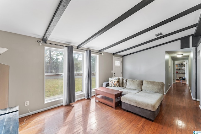 living area with vaulted ceiling with beams, visible vents, baseboards, and hardwood / wood-style floors