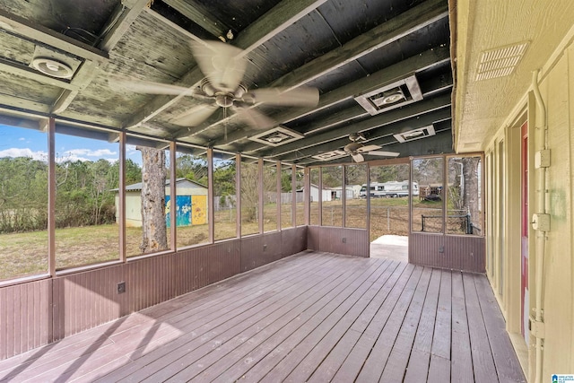 unfurnished sunroom with a ceiling fan