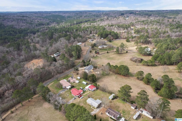 drone / aerial view with a wooded view