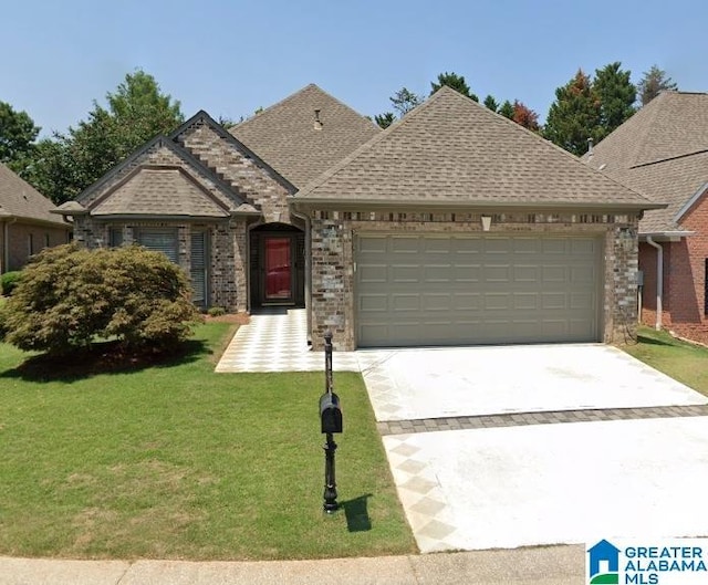 view of front of property featuring a garage, roof with shingles, concrete driveway, and a front yard