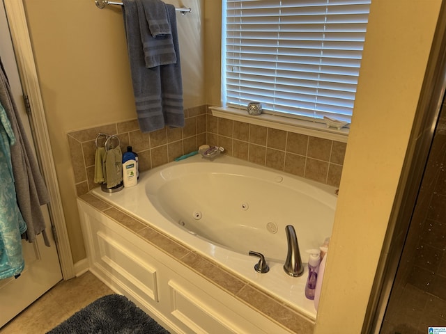 full bathroom with a whirlpool tub and tile patterned flooring